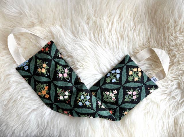 Floral patterned face mask on a white fluffy surface