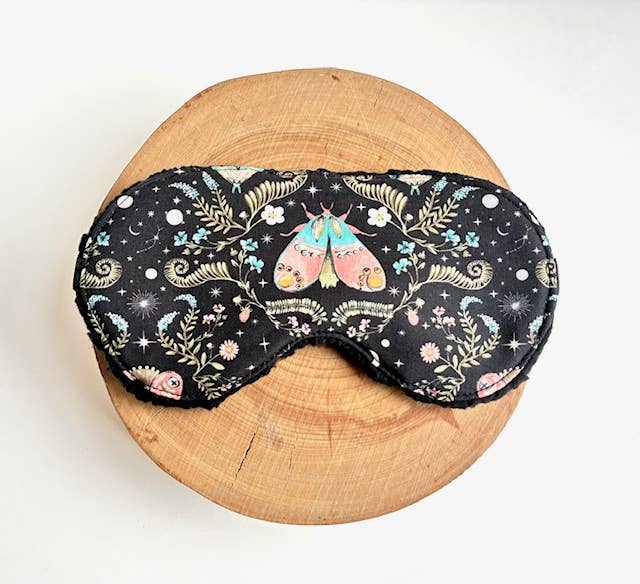 Sleep mask with a moth on white background.