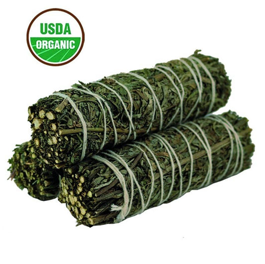 Two bundles of green herbs tied with twine on a white background, with an USDA Organic label.