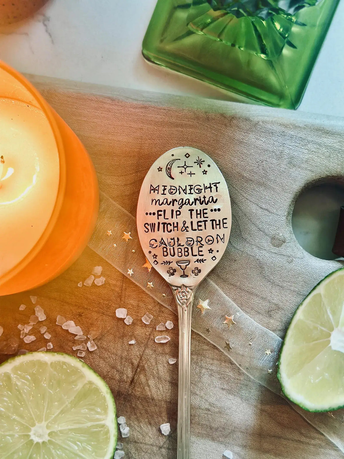 A decorative spoon with hand-lettered text reading 'Midnight margarita.
