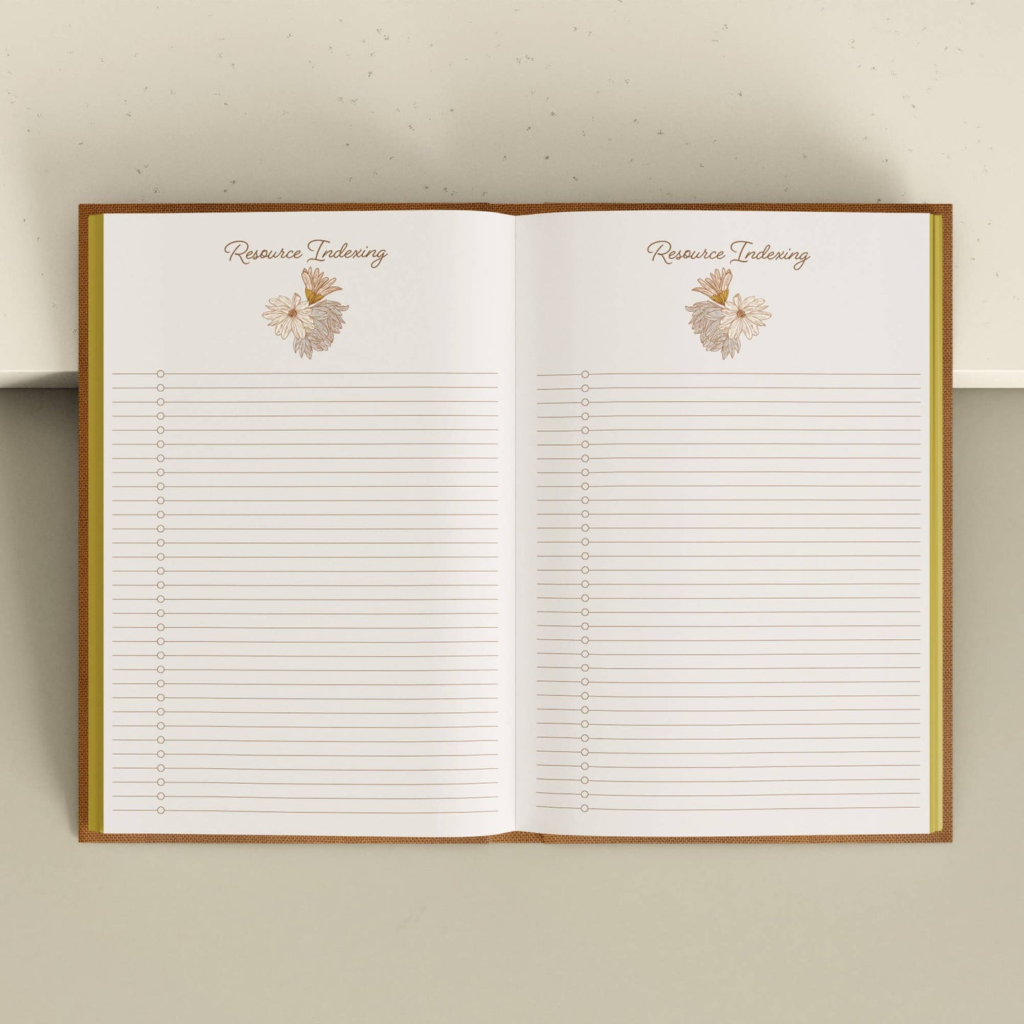Open notebook with lined pages and floral designs on a light background