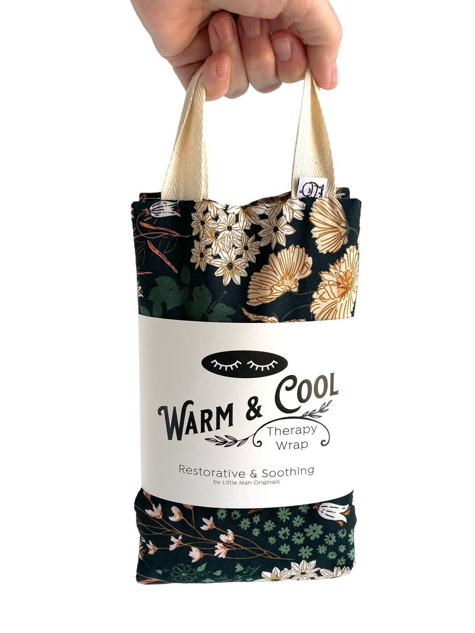Hand holding a floral-patterned therapy wrap with 'Warm & Cool' branding on a white background
