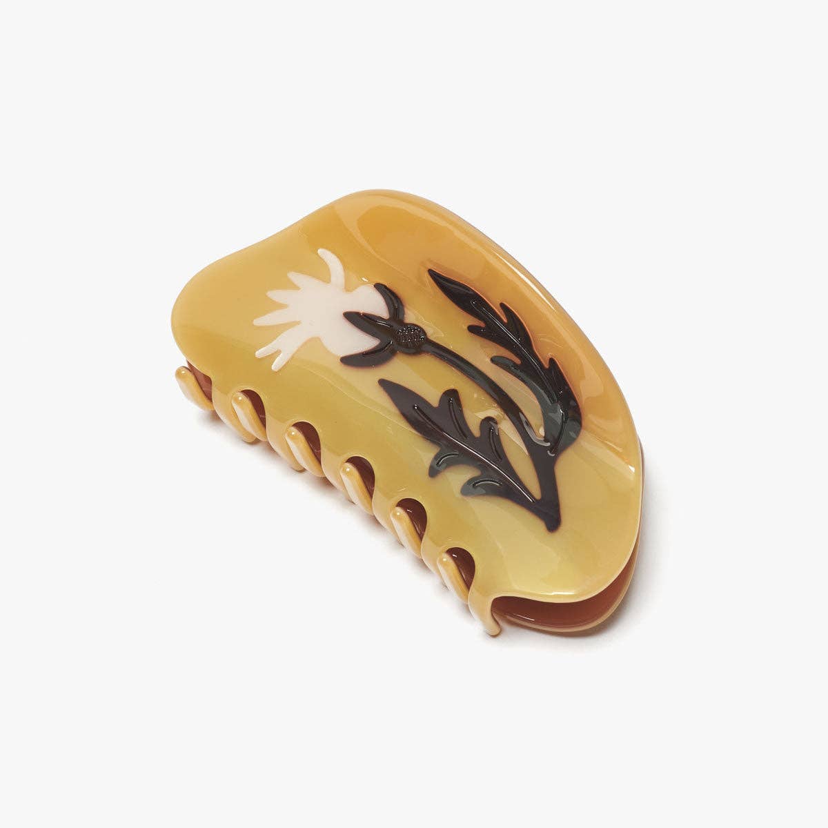 Yellow hair clip with floral design on a white background