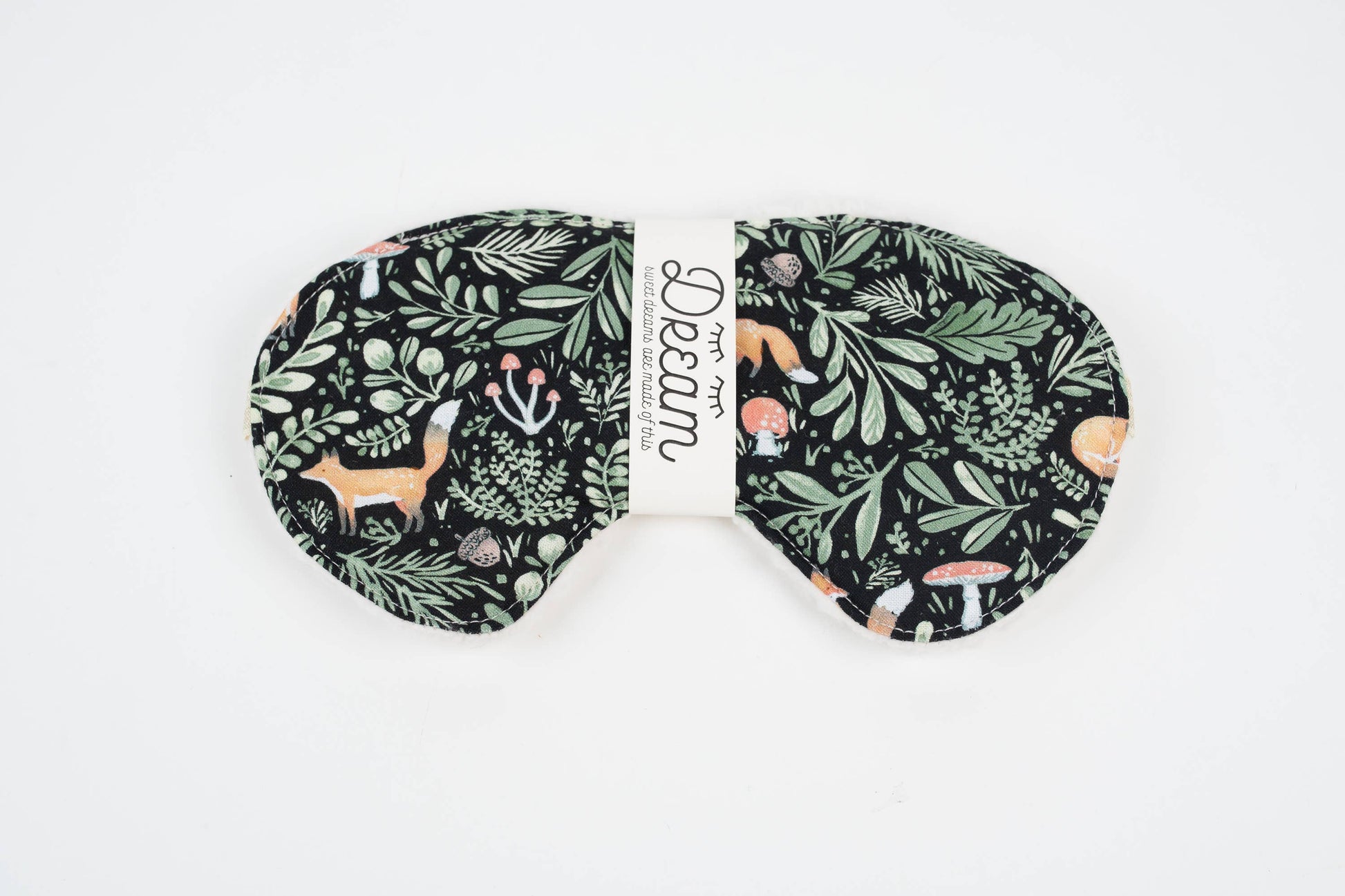 Sleep mask with nature-themed design on a white background