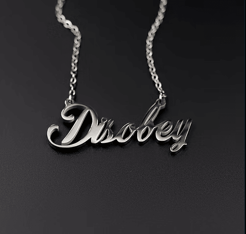 Silver 'Disobey' necklace on a black background