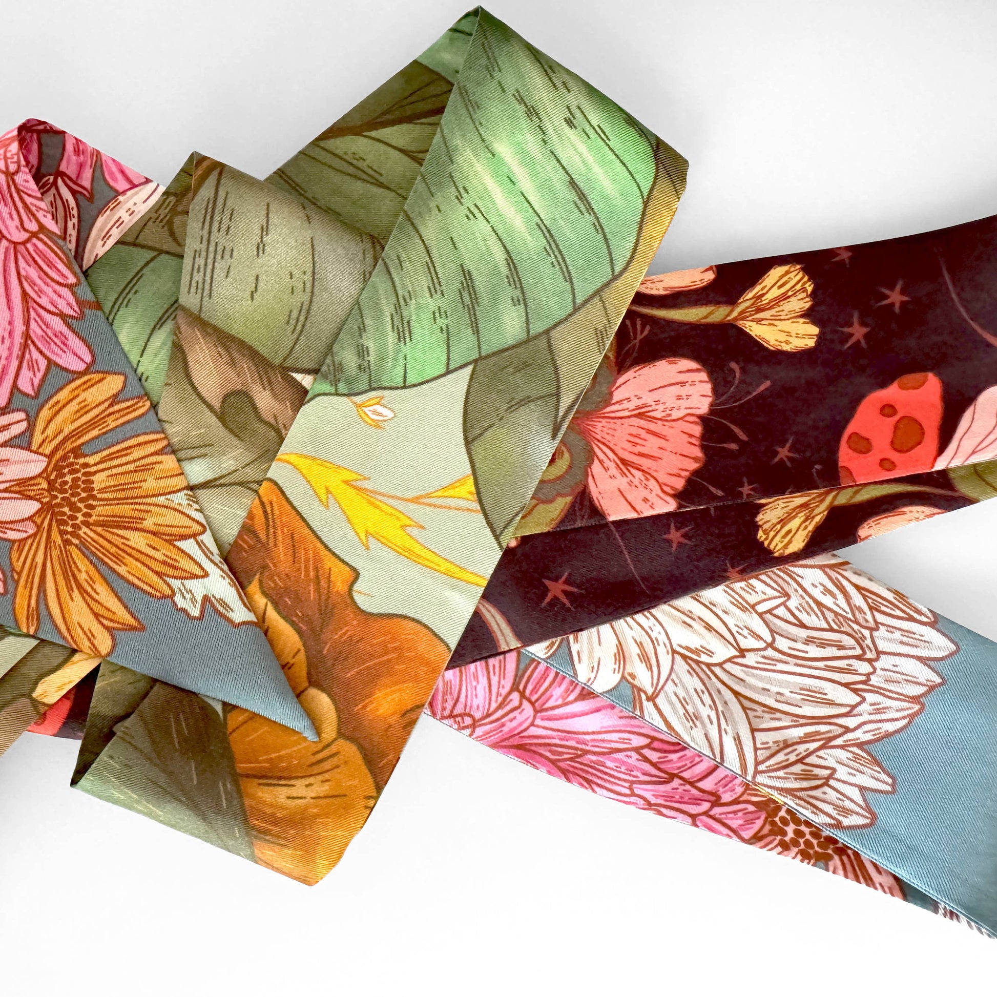 Colorful floral-patterned paper pieces on a white background