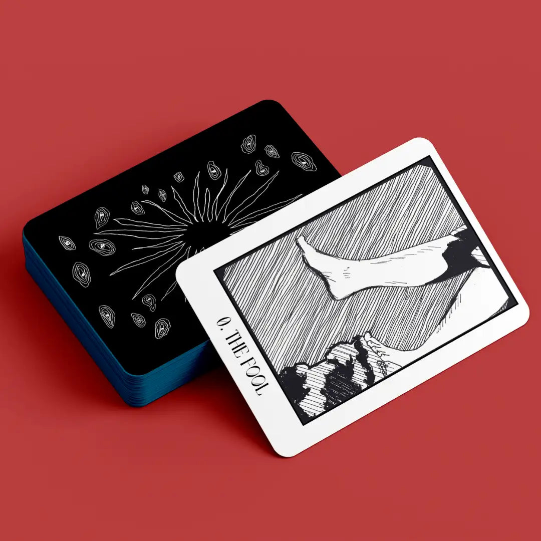 Black and white tarot card with 'The Fool' on a red background
