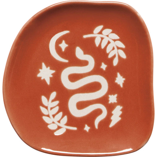 Ceramic plate with white snake design on a red-brown background