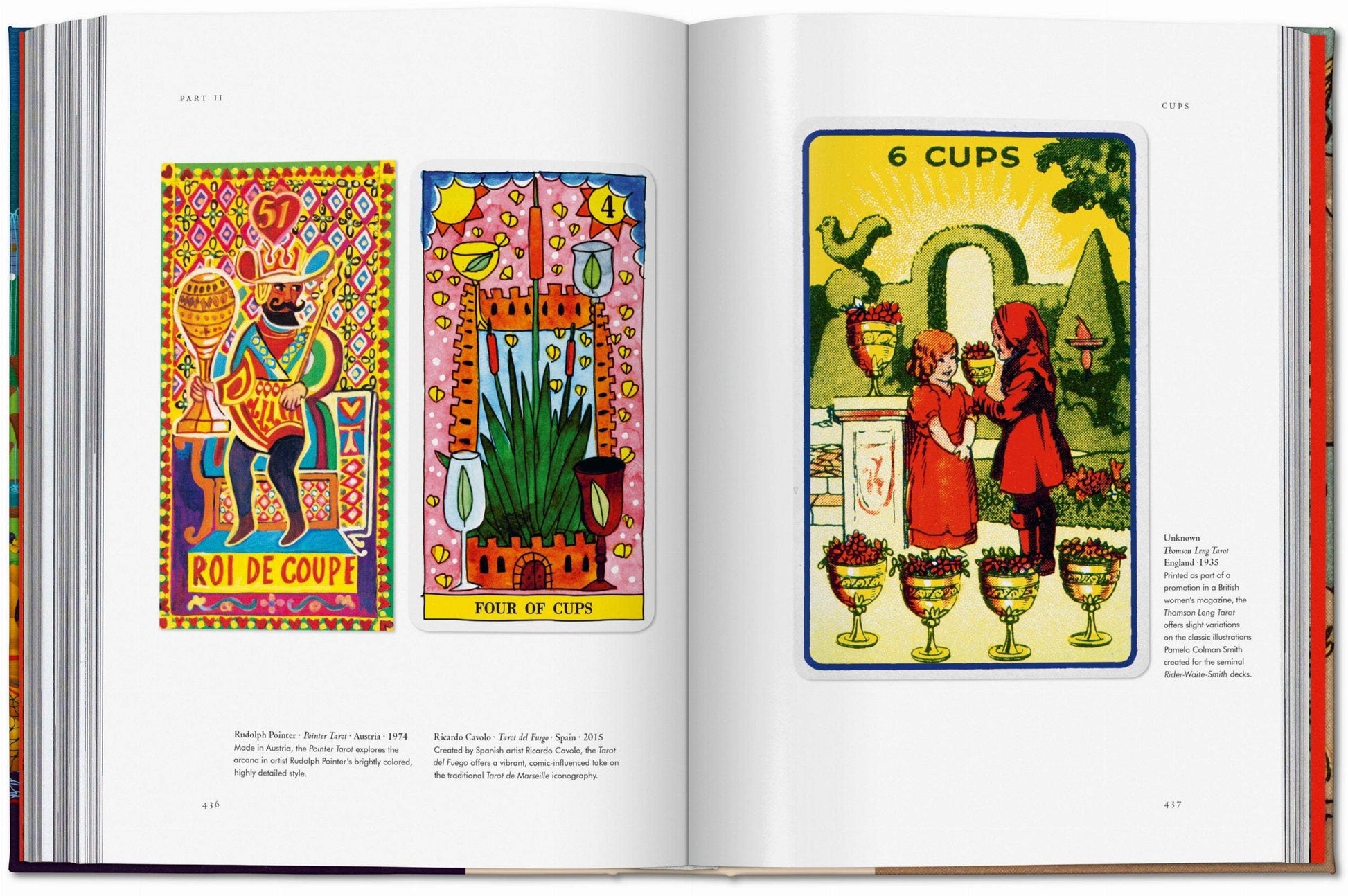 Open book displaying colorful illustrations of tarot cards or similar artwork.