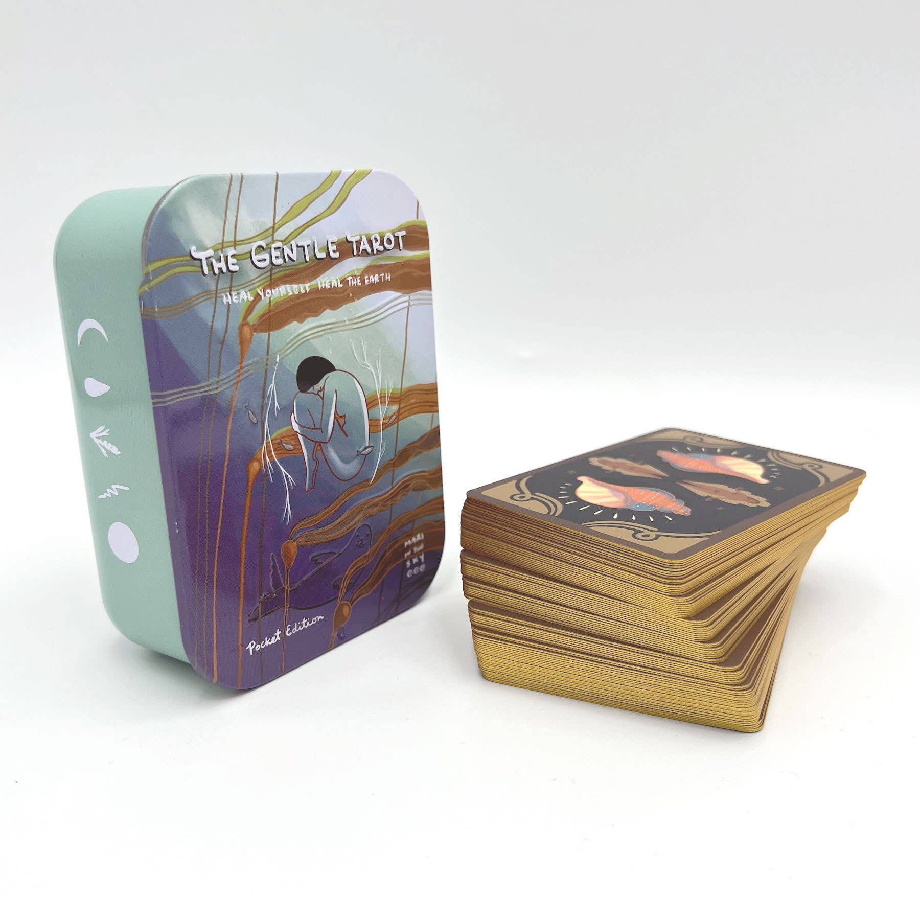 Tarot card set with a tin box labeled 'The Gentle Tarot' on a white background