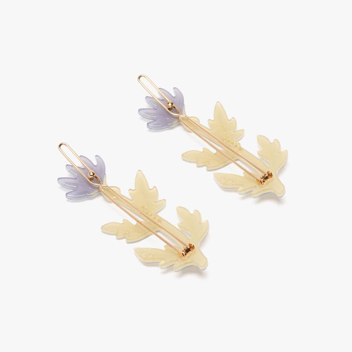 Gold and purple leaf-shaped earrings on a white background