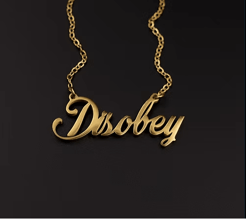 Gold necklace with 'Disobey' pendant on a black background