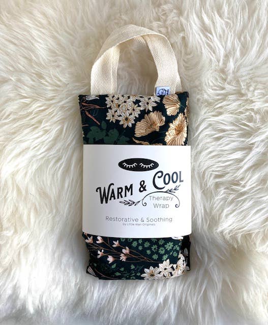 Floral patterned 'Warm & Cool' therapy wrap on a fluffy white surface