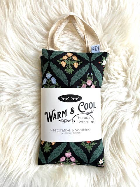 Floral patterned therapy wrap with 'Warm & Cool' label on a fluffy white surface