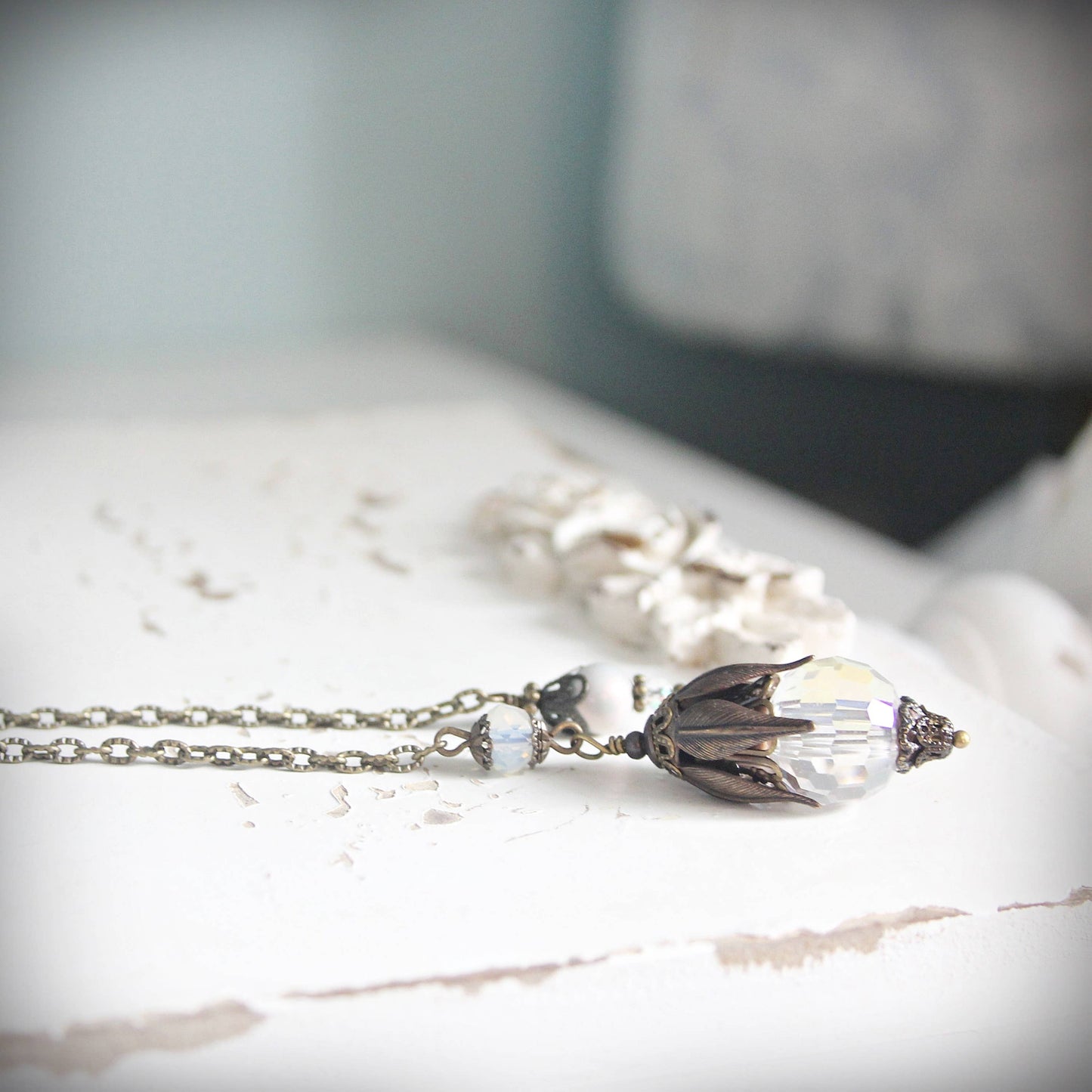 Pendulum with a decorative pendant on a marble surface
