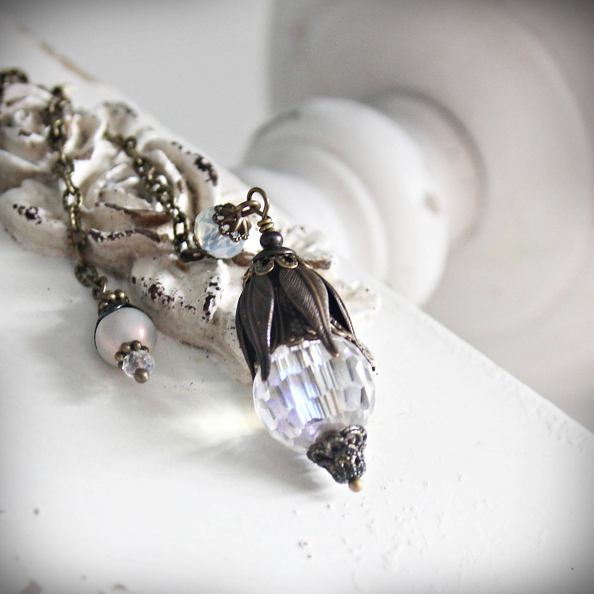 Pendulum with decorative pendant on a white surface