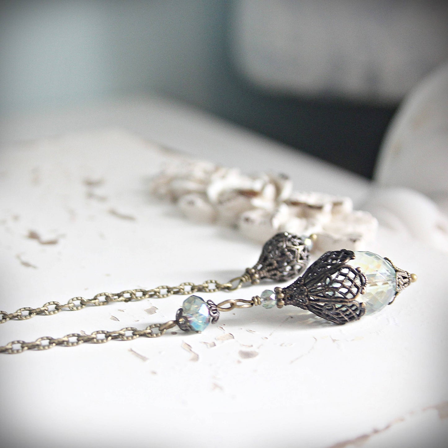Delicate pendulum with floral pendant on a marble surface