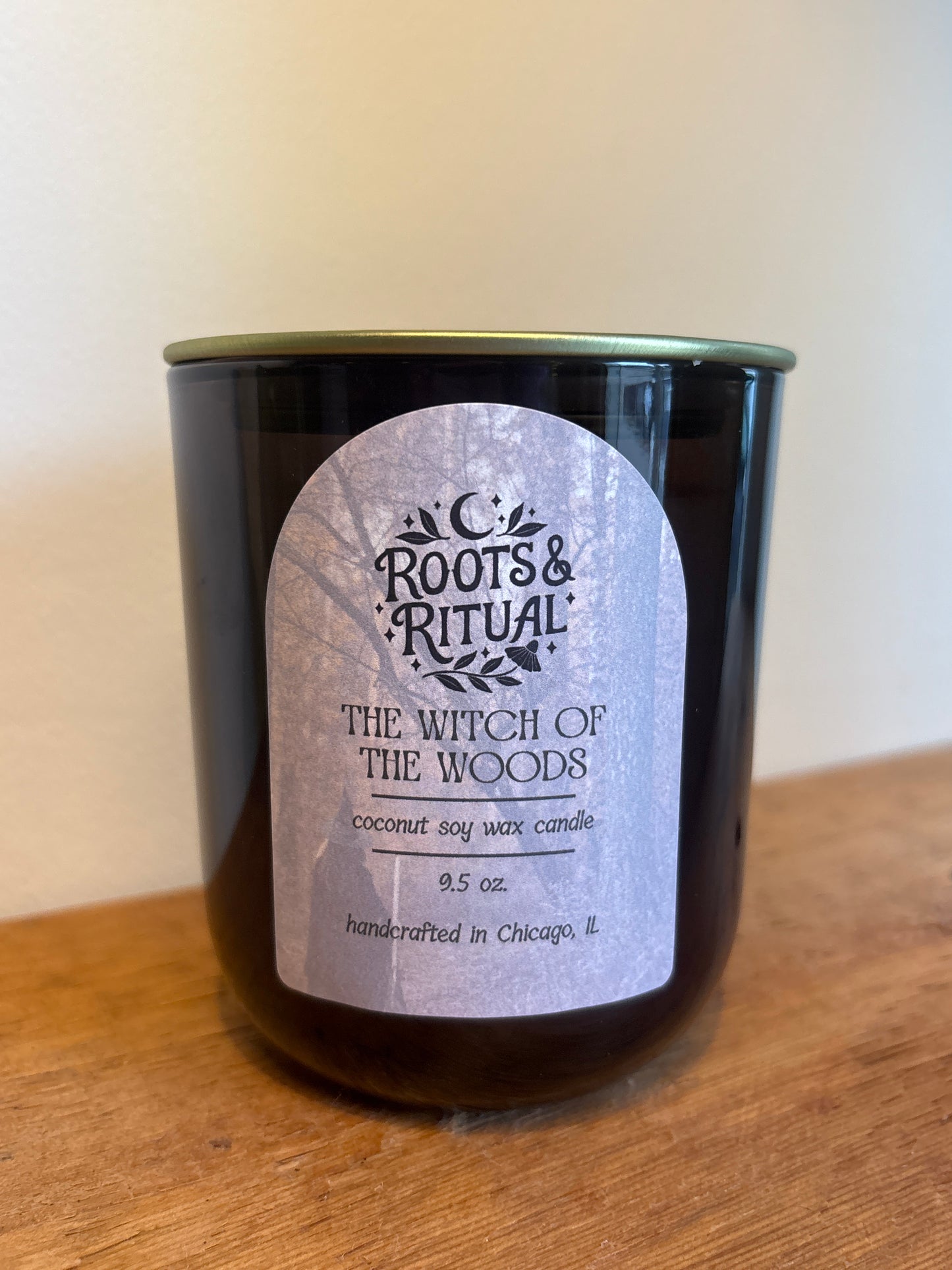 Candle with a label on a wooden surface